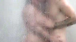 Busty amateur milf masturbates in the shower