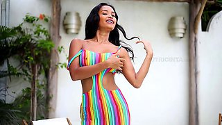 Putri Cinta in a colorful dress teases by stripping to reveal her tight backside