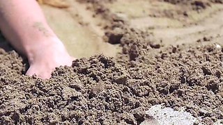 Russian blonde MILF strips nude at beach