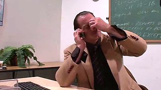 Tattooed dark haired in a classroom with cumshot