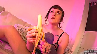 A hot brunette plays with a dildo on the sofa while masturbating solo.