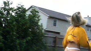 Outdoor solo masturbation scene with curly blonde