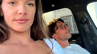 Sexy brunette babe plays with boyfriend's cock in car ride