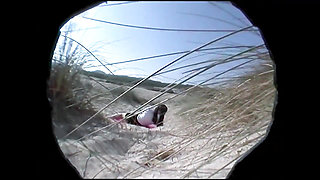 A hairy teen shoots her boyfriend with a camera on the beach