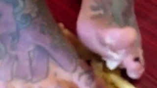 A banana is trampled by a blonde tattooed MILF