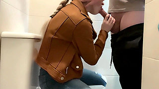 Busty Blonde Sucks Cock in the School Bathroom