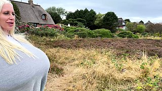 Blonde is flashing her big boobs in the outdoors