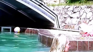 Two horny lesbians masturbate with toys outdoor by the pool