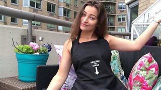 Funny brown haired girl in dark-hued top on balcony