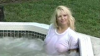 Sizzling hot and playful blonde busty babe in the hottub