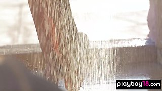 Nude teenage poses under the shower outdoor