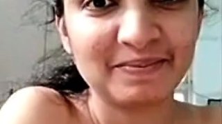 Busty indian milf strips nude to show round tits on webcam