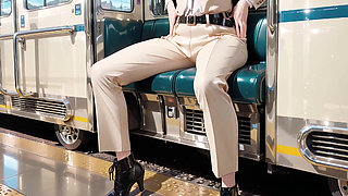 Leaning Against the Vintage Train Door, She Runs Her Hand Down Sheer Stockings While Gazing with a Cold yet Misty Look