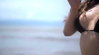 Sexy Latina MILF in bikini posing seductively on the beach