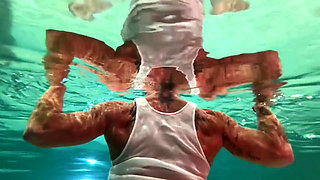 Amazon Kandy Flexes Her Massive Biceps in Her Hotel Pool