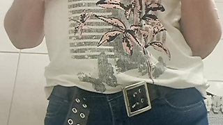 MILF taking off her clothes, urinating, leaving her vagina wet and hot.