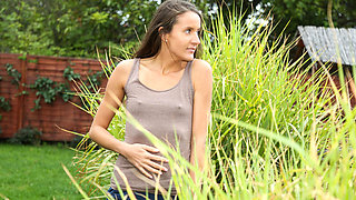 European girl is naked in the field and fingers herself