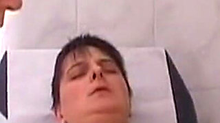 Mature Nurses Intimately Explore Patient on Exam Table