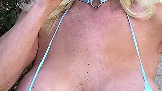 Blonde is flashing her big boobs in the outdoors