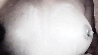 A girl roughly fondles her large breasts