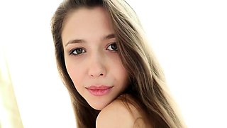 Busty brunette beauty poses naked and plays with herself