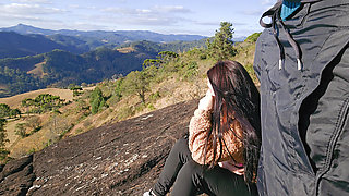 Tour guide shows stick to tourist on mountain