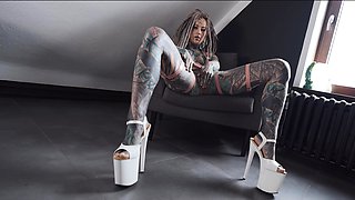 Gorgeous tattooed girl fucks her ass with a big dildo