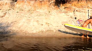 Tattooed Babe Strips and Swims on a SUP Board in the Forest