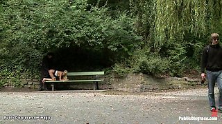 Slave posing naked in public window