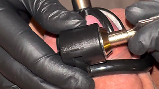 Athena plays with Nikos's cock while it's locked in chastity