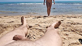 Stepsister gives nude blowjob to stepfather on a beach