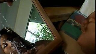 Asian girl is milking her tits in the mirror for you