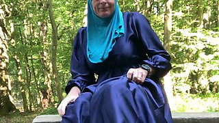 Fatima masturbates on a bench in the forrest