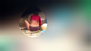 I see my step sister in the outdoor bathroom cleaning her pussy hair in the open bathroom and taking a bath.